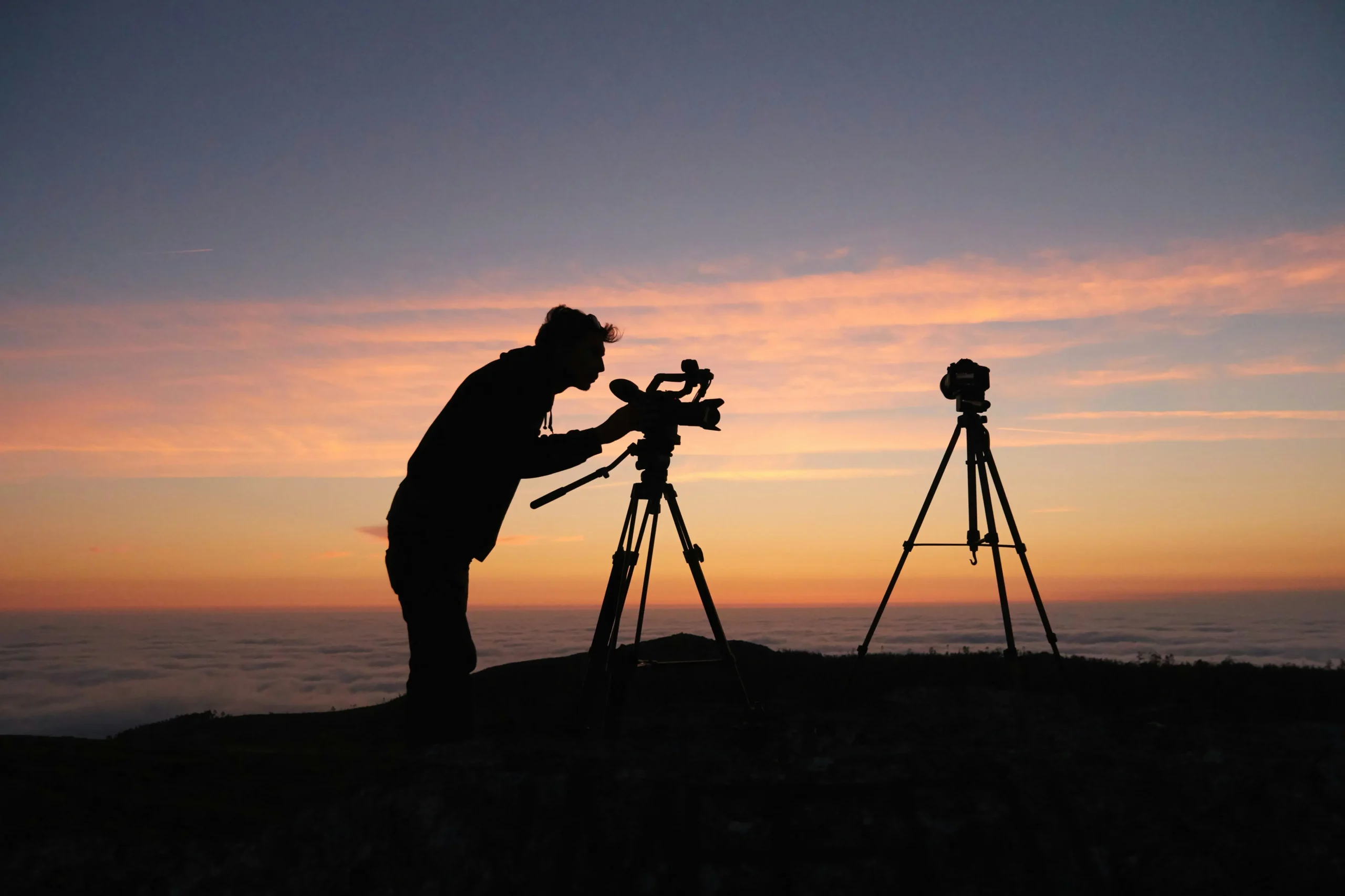 silhouette image of a photographer at sunset